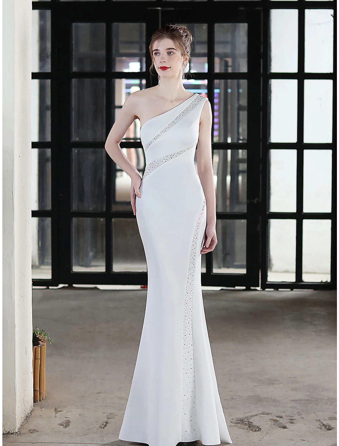 Close-up of crystal embellishments on the stretch satin dress.