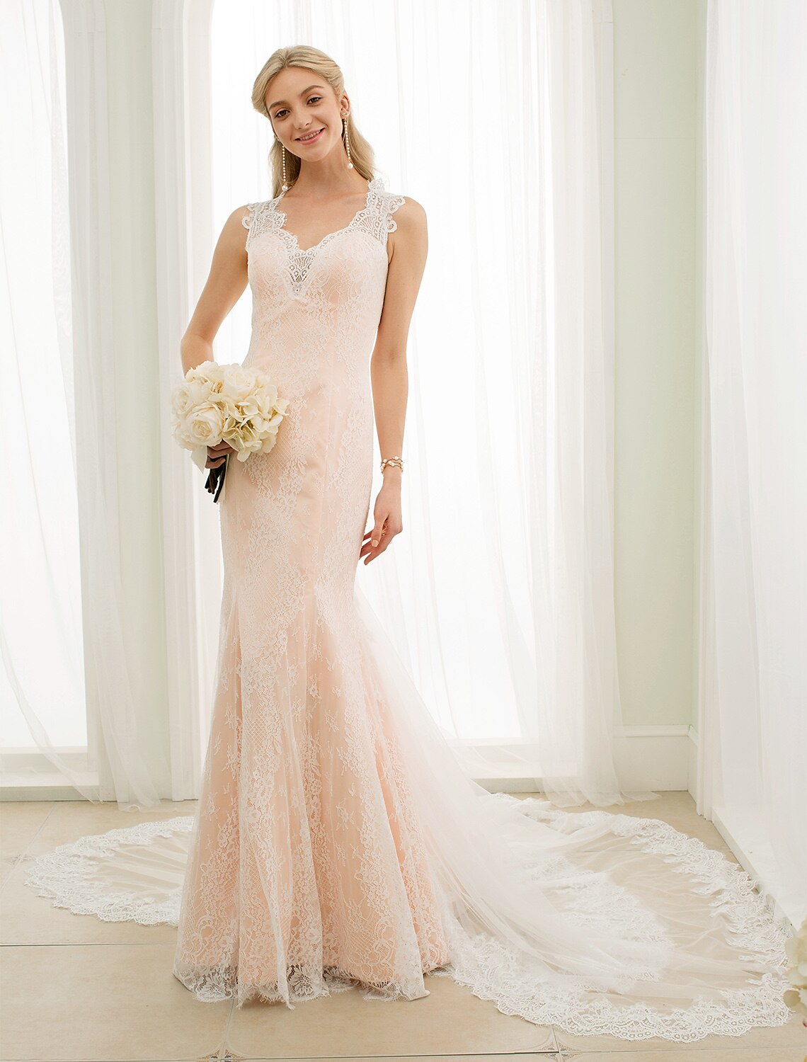 Elegant Mermaid Trumpet wedding dress with plunging neckline and lace appliques.