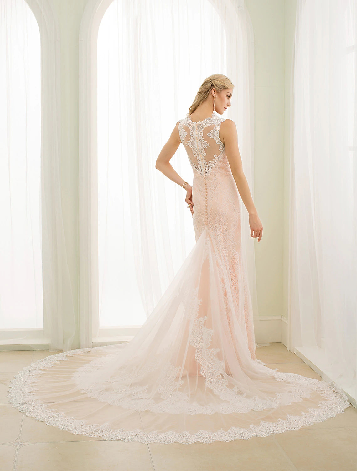 Back view of Mermaid Trumpet wedding dress showing chapel train and button details.