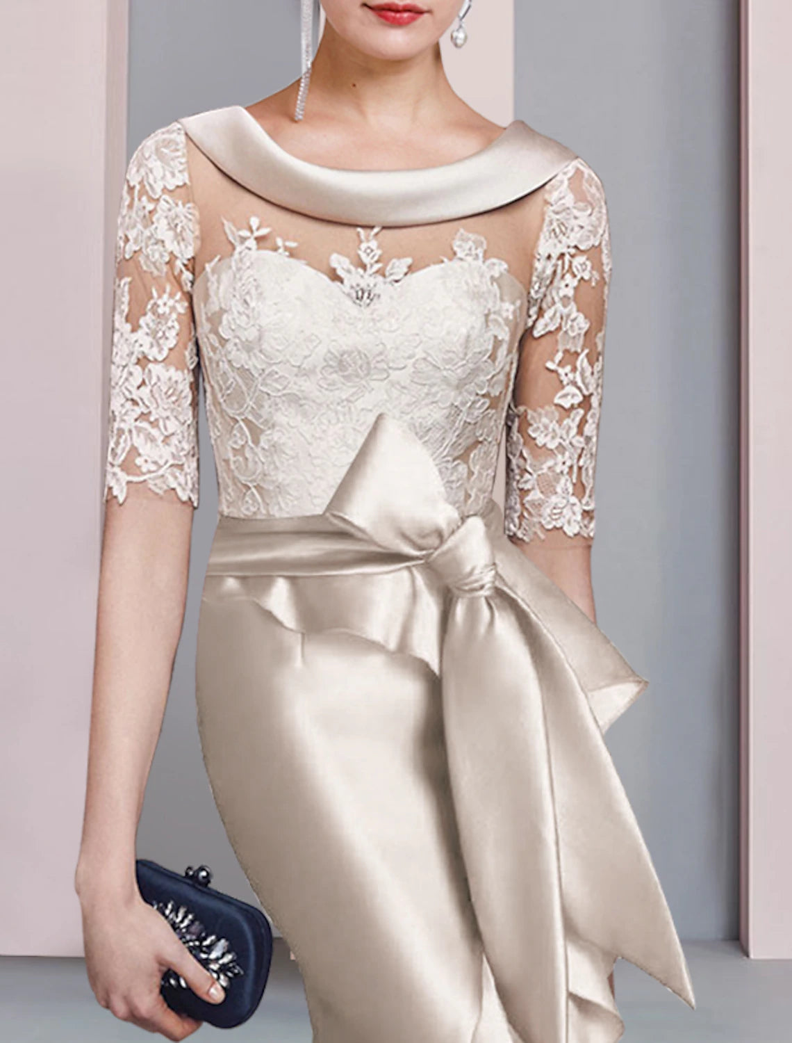 Woman posing in the navy Mother of the Bride dress, emphasizing its elegant silhouette.