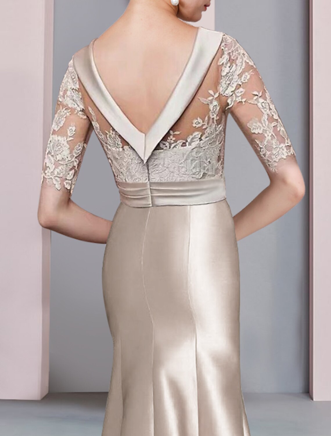 Detailed view of the satin and lace fabric on the navy formal dress with bow embellishments.