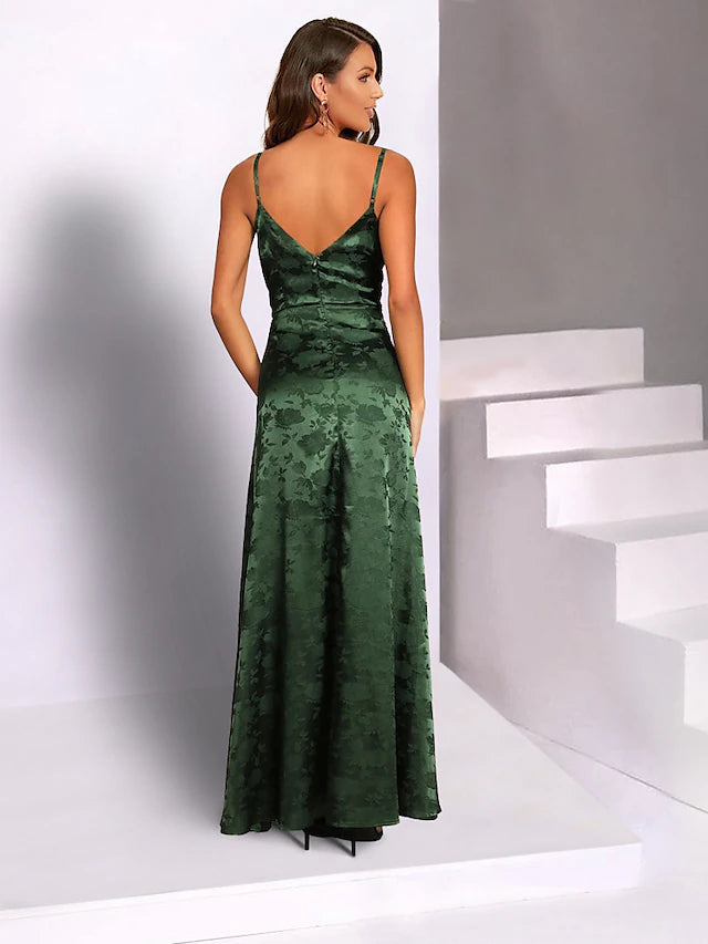 Side profile of the woman in the mermaid trumpet dress, highlighting the flowing skirt and slit.