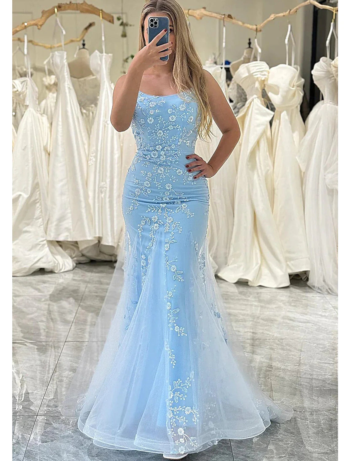 Elegant mermaid trumpet prom dress with spaghetti straps and sequin appliques.