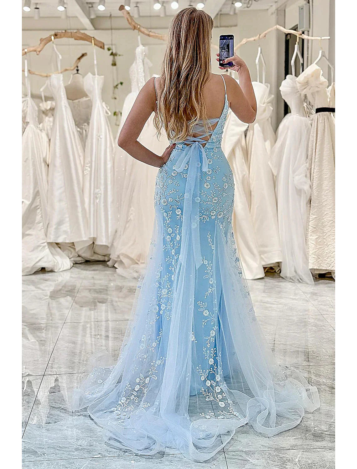 Back view of a mermaid trumpet formal dress with floor-length tulle.