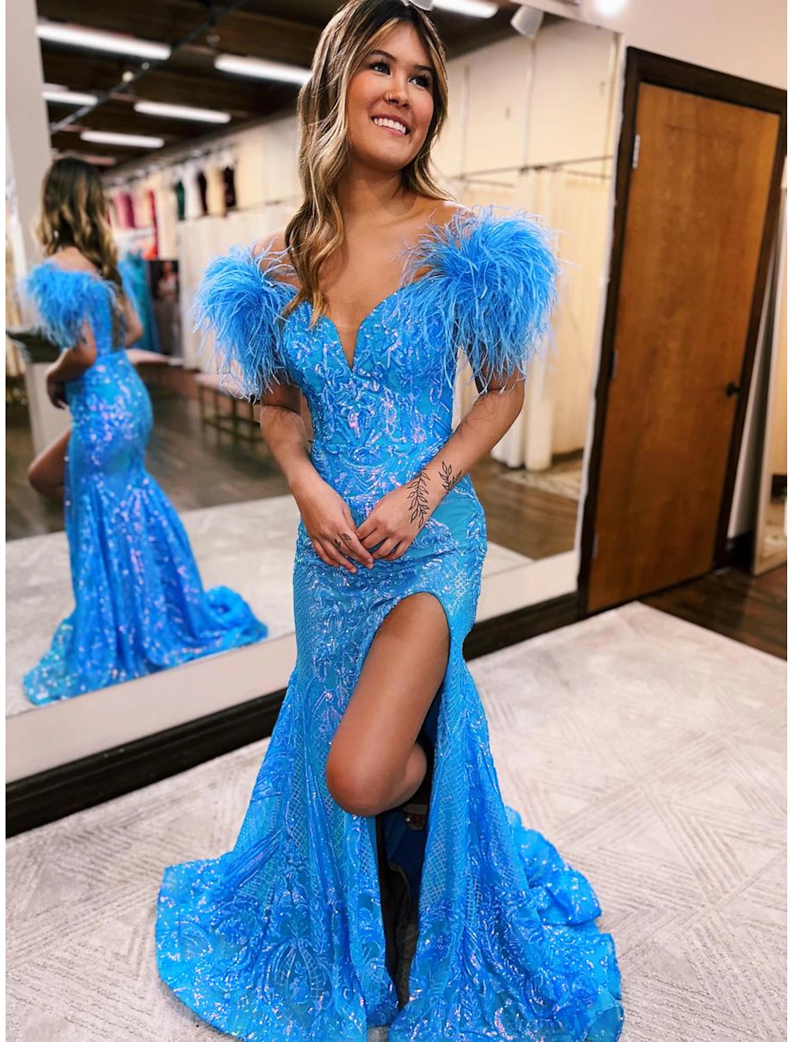 Navy blue sequined mermaid trumpet prom dress with V-neck and court train.