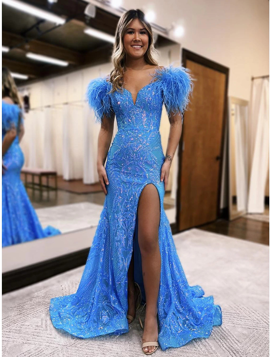 Close-up of the sparkling navy blue sequined fabric on a mermaid prom dress.