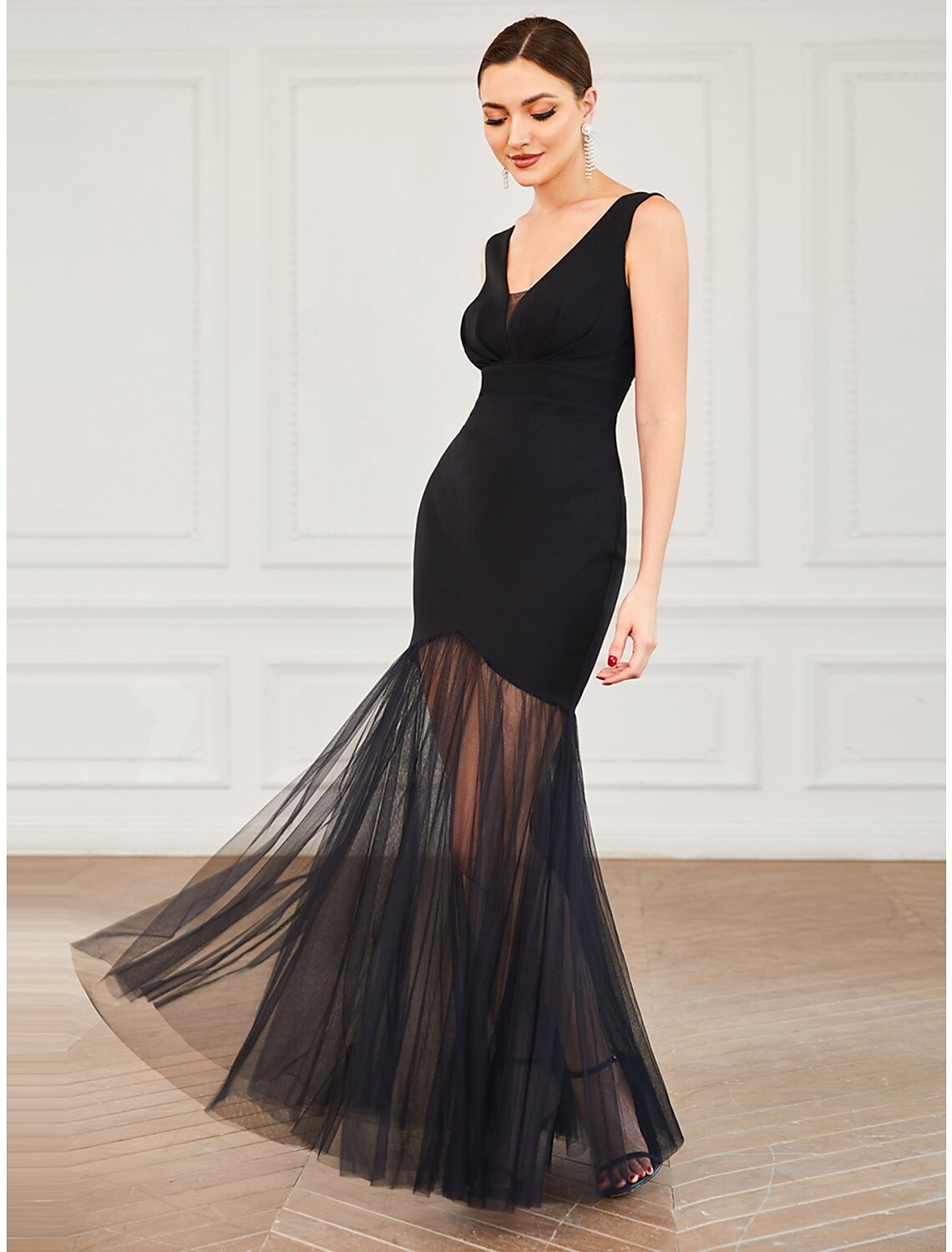 Side view of the black mermaid trumpet gown, highlighting the draped silhouette.