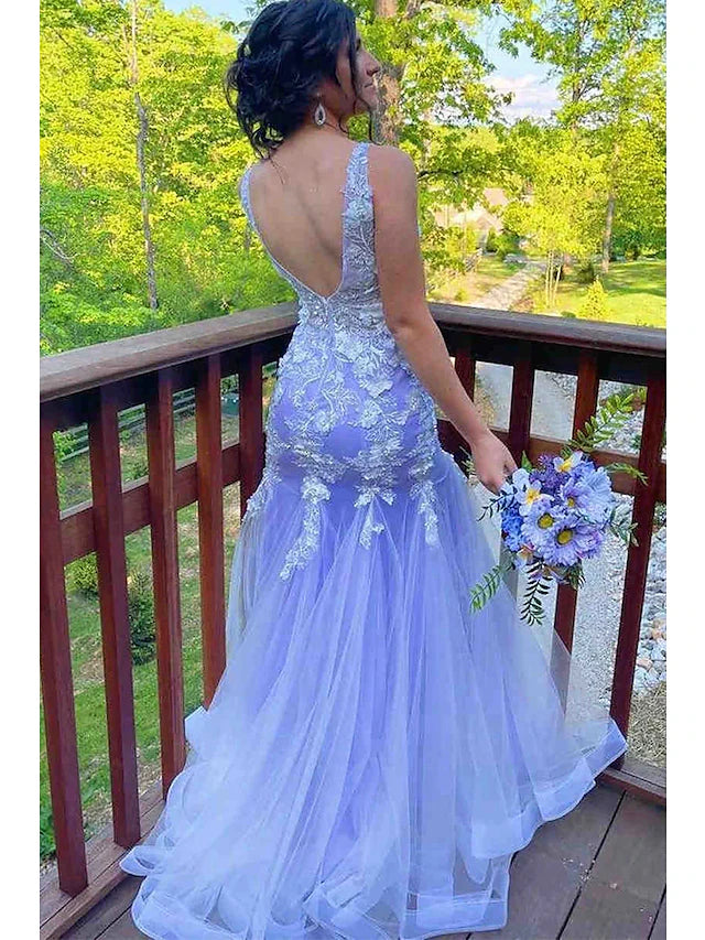 Full length view of a sleeveless mermaid trumpet formal gown with ruffles and sweep train.