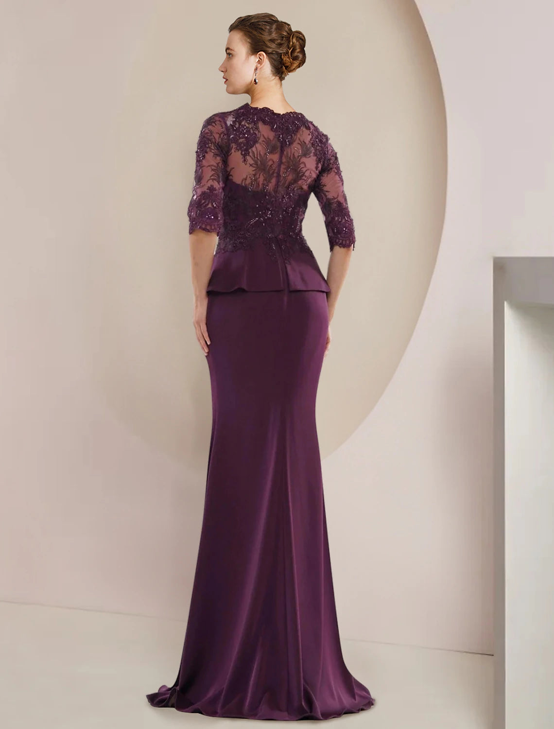 Close-up of the lace, beading, and ruffle appliques on the formal V-neck gown.