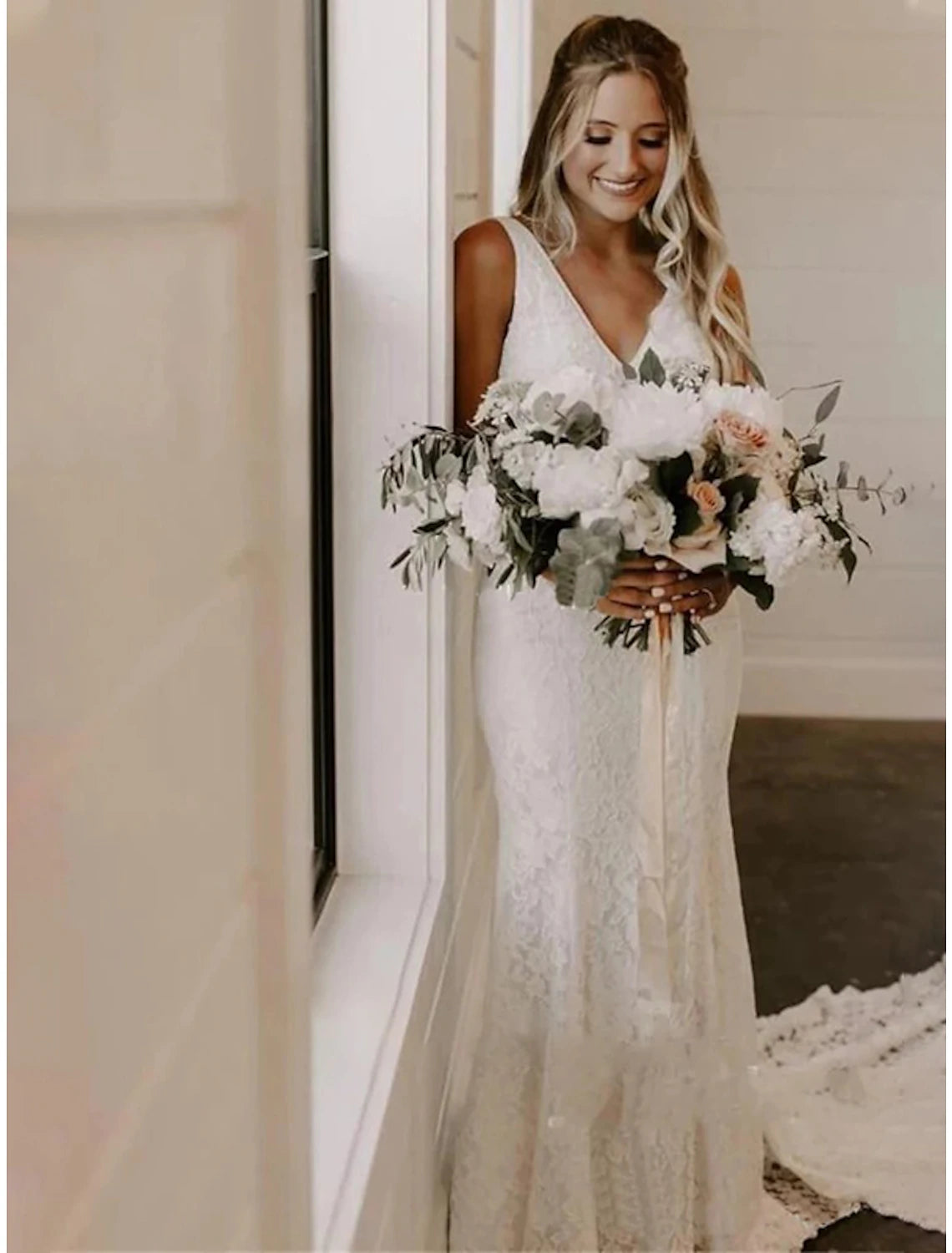 Back view of an elegant bridal gown showing the court train and intricate lace details.