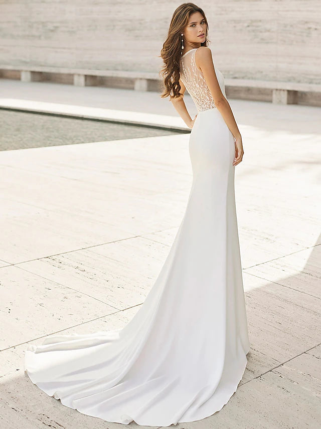 Sleeveless V-neck bridal gown in satin with delicate appliques.
