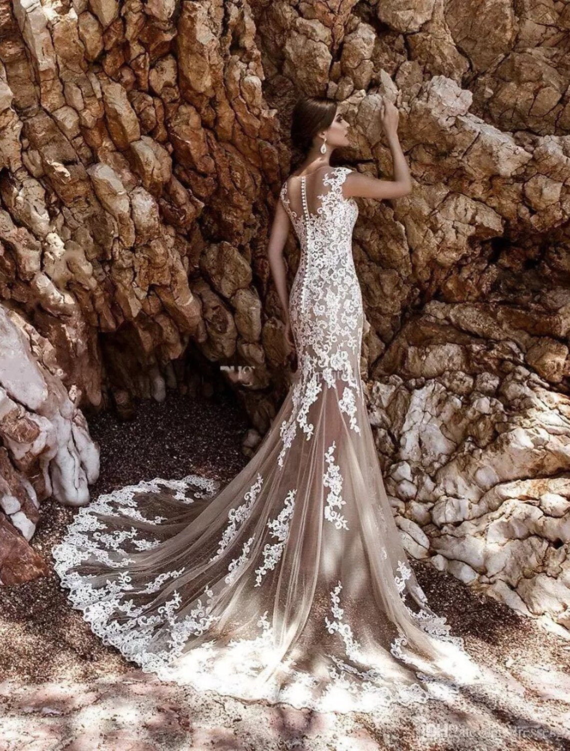 Close-up of the illusion neckline and cap sleeves with delicate lace detailing on the bridal gown.