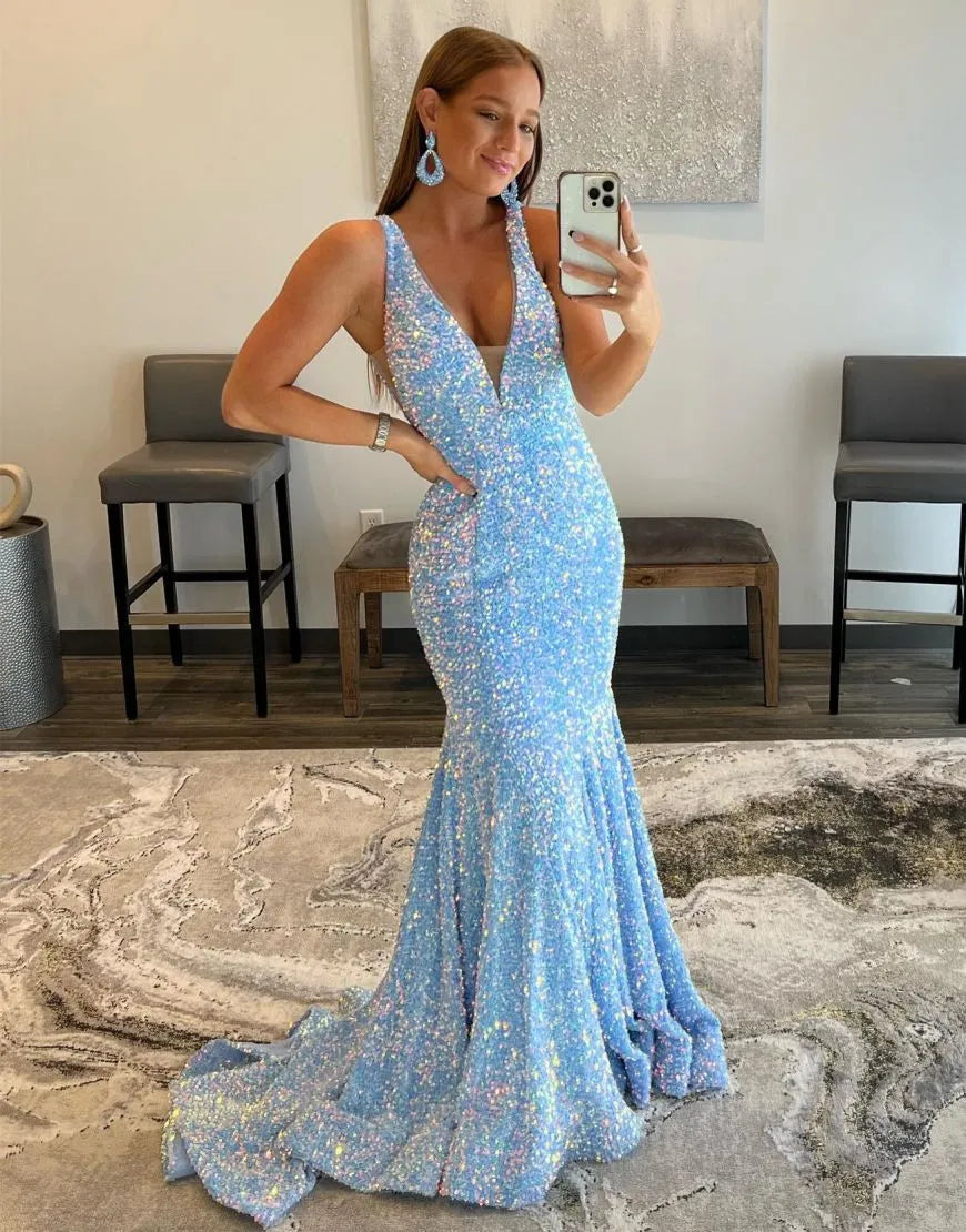 Full-length view of a woman wearing an elegant mermaid V-back prom dress.
