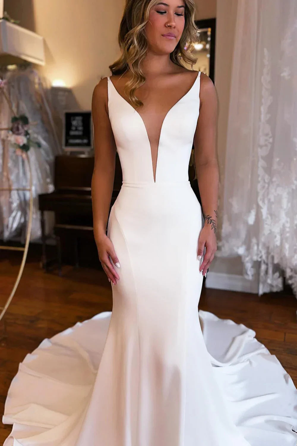 Side profile of the mermaid wedding dress, showcasing its elegant silhouette.