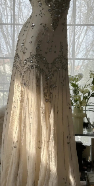 Back view of a white elegant mermaid prom dress.