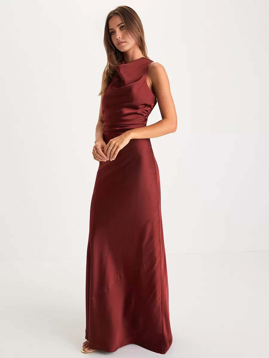 A woman wearing an elegant floor-length mermaid V-neck formal dress with a crossover back.