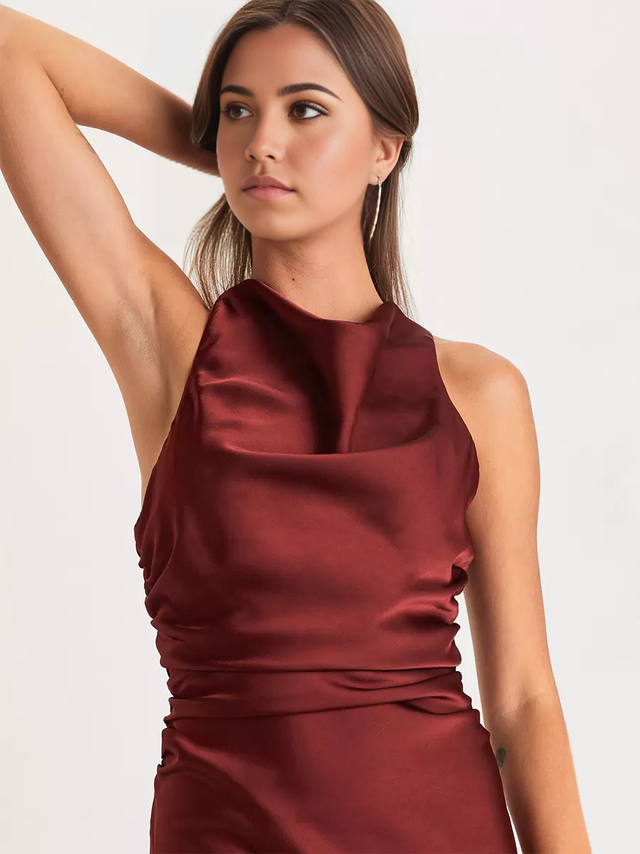 Back view of an elegant mermaid V-neck formal dress, highlighting the crossover strap design.