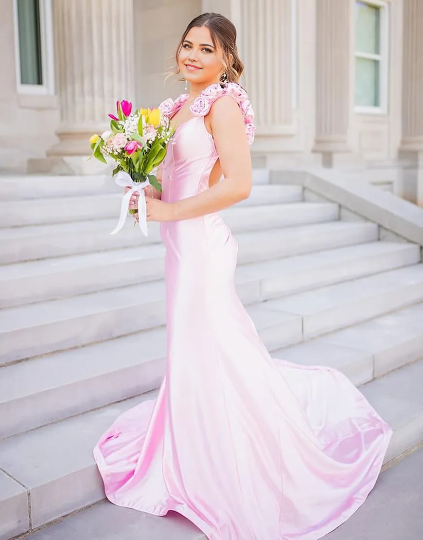 Elegant pink mermaid prom dress with floral details and V-neckline.