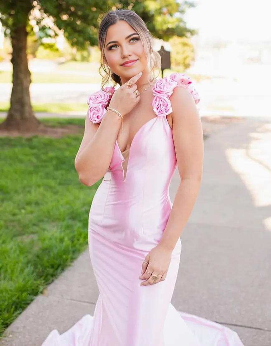 Side view of a pink mermaid evening gown, showcasing the silhouette and shoulder straps.
