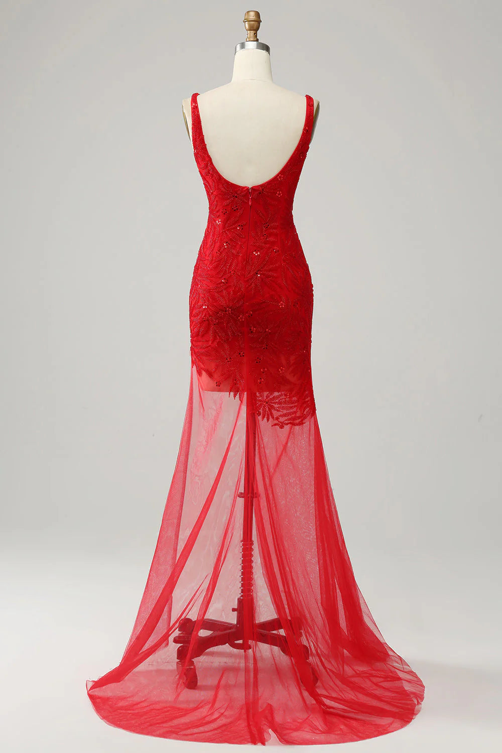 Side view of a model wearing a red mermaid V-neck formal gown.