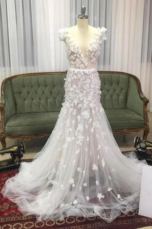 Mermaid V-neck wedding dress with handmade floral details on tulle fabric.
