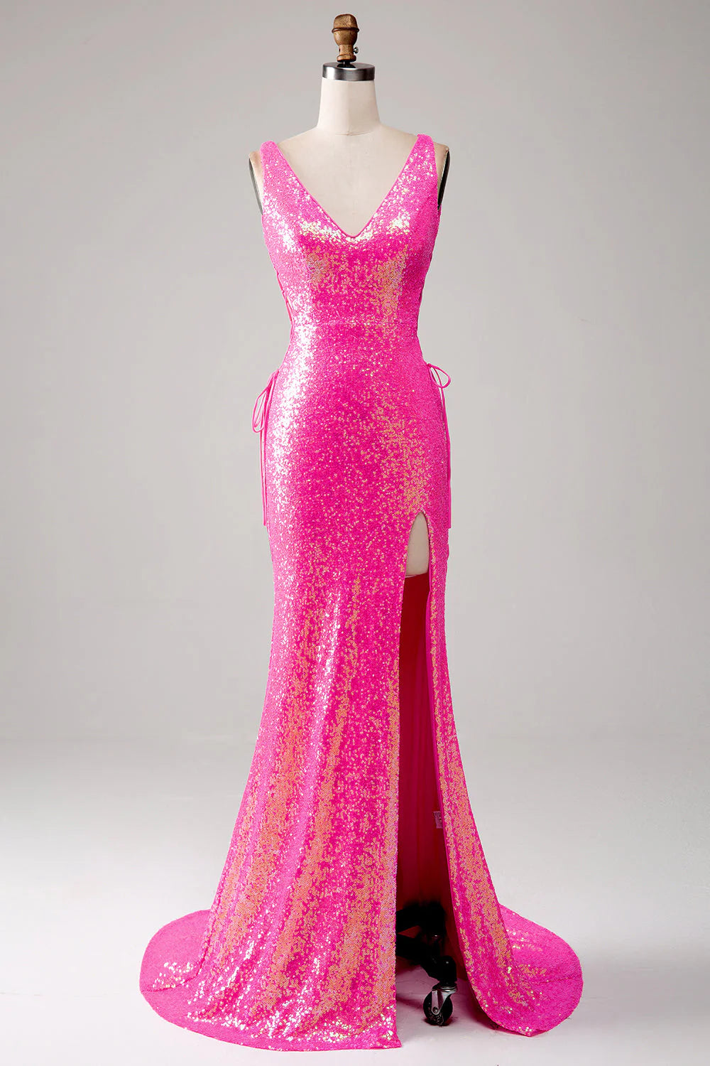 Woman in an elegant mermaid V-neck prom dress with a high slit.