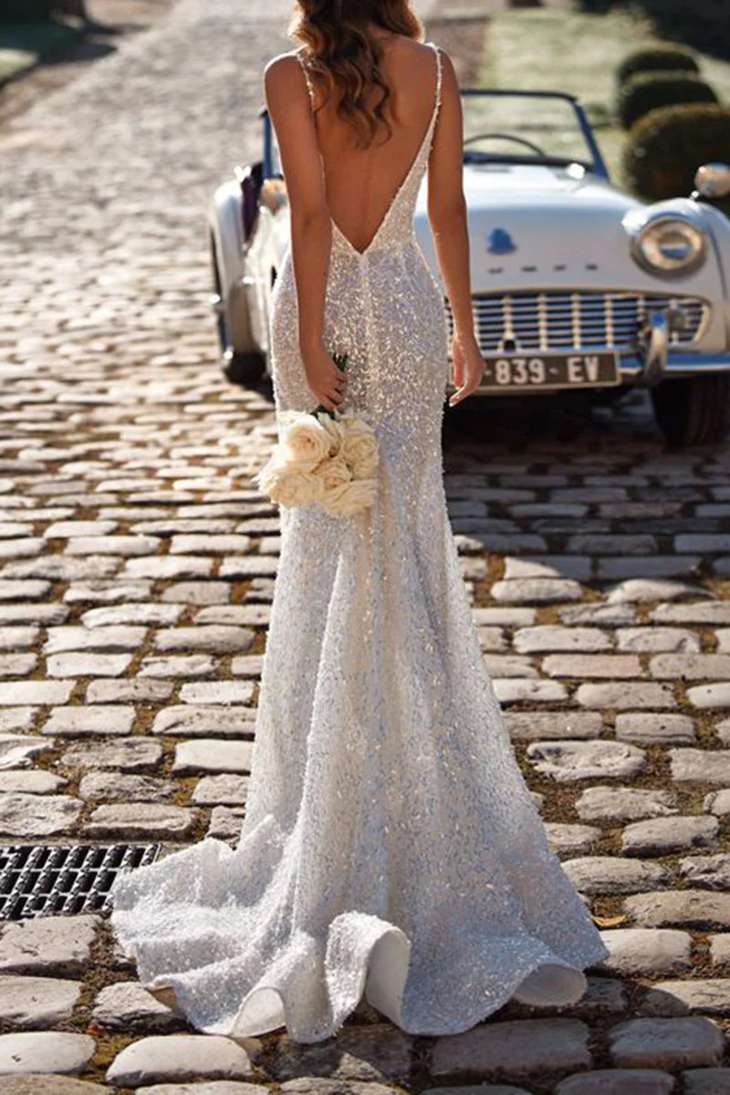 Side view of a woman in a mermaid V-neck wedding dress, highlighting the high split.