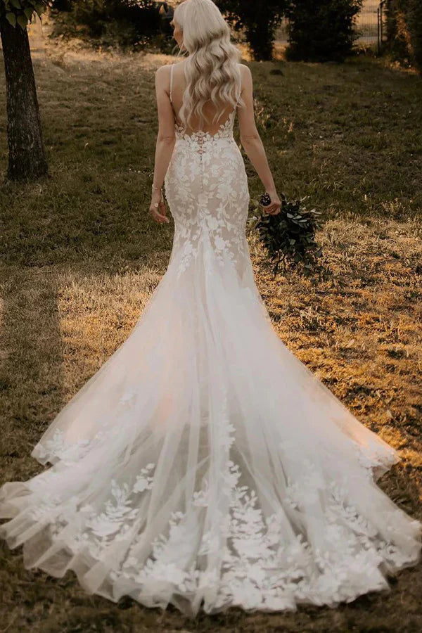 Close-up of delicate lace appliques on a mermaid wedding dress.