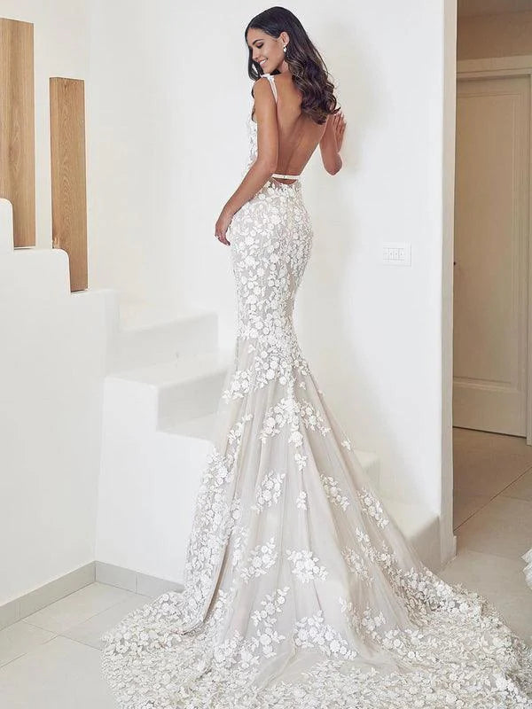 Close-up of the V-neck bodice and lace straps on a bridal gown.
