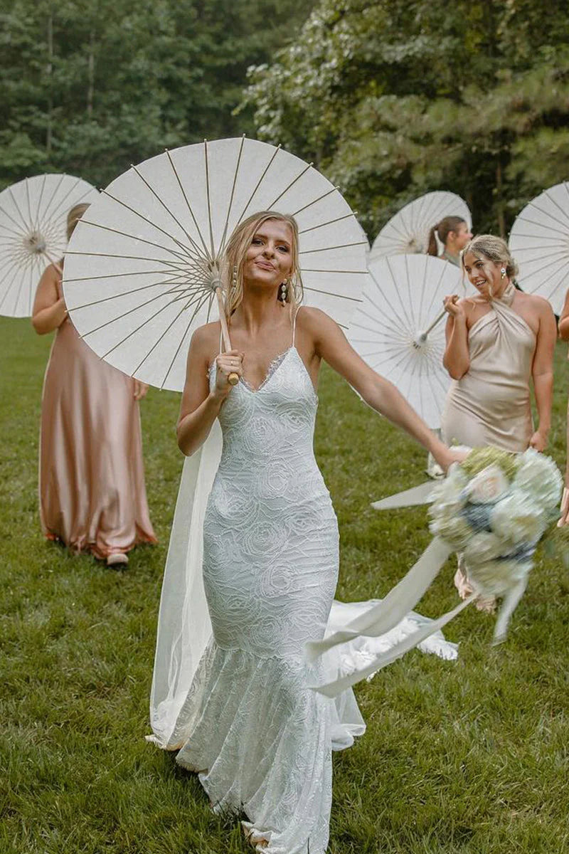 Elegant mermaid V-neck lace wedding dress with bohemian details.
