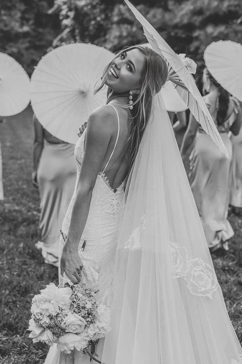 Back view of a bride wearing a mermaid lace wedding gown.