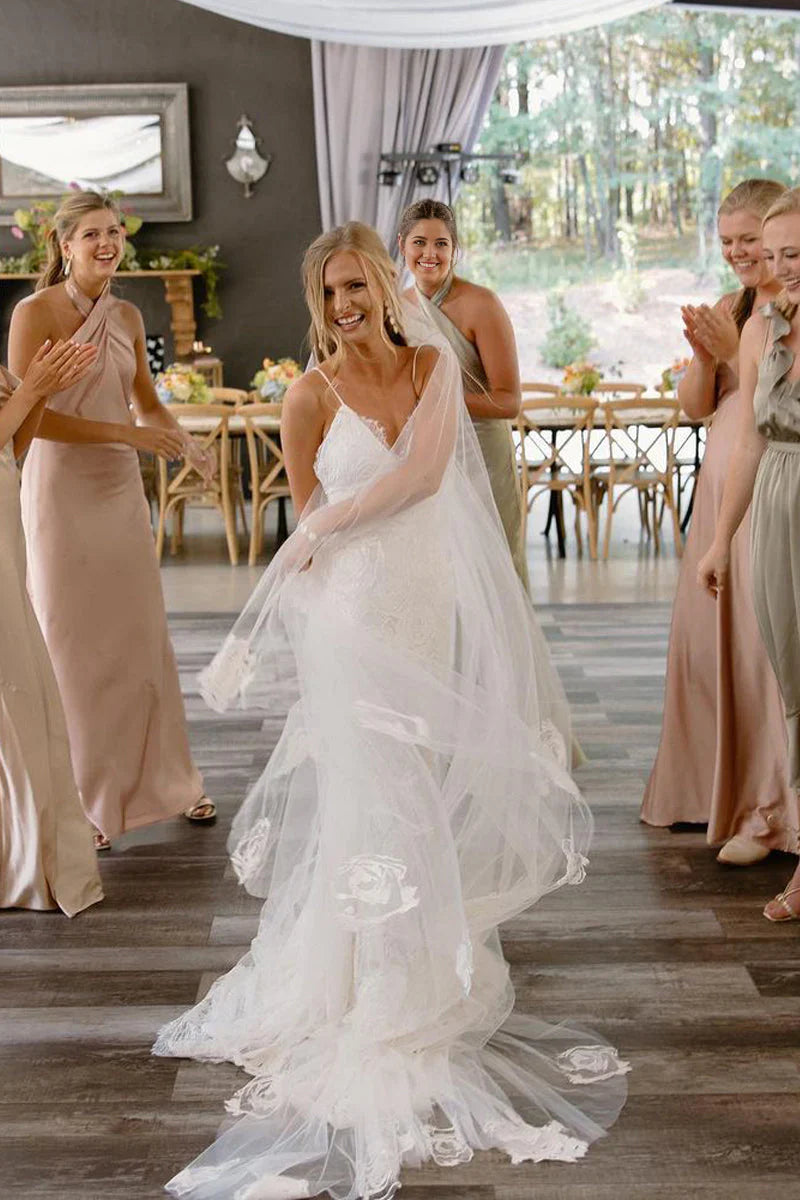 Close-up of the V-neckline and intricate lace details on a boho wedding dress.