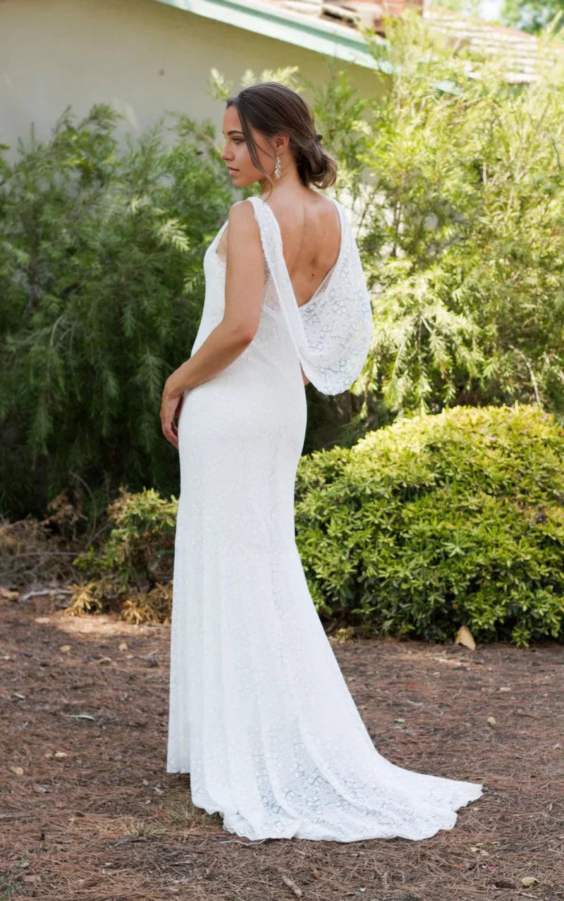 Back view of mermaid wedding dress highlighting lace and low back design.
