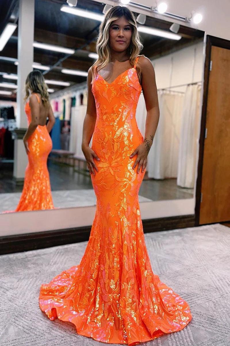 Woman wearing an elegant mermaid V-neck lace sequin long prom dress.