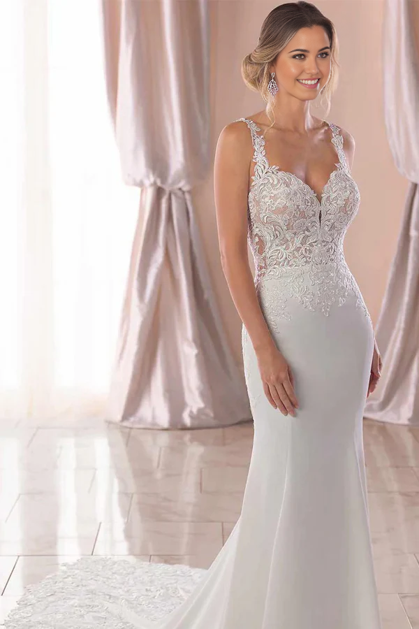 Elegant ivory mermaid wedding dress with lace straps and court train.