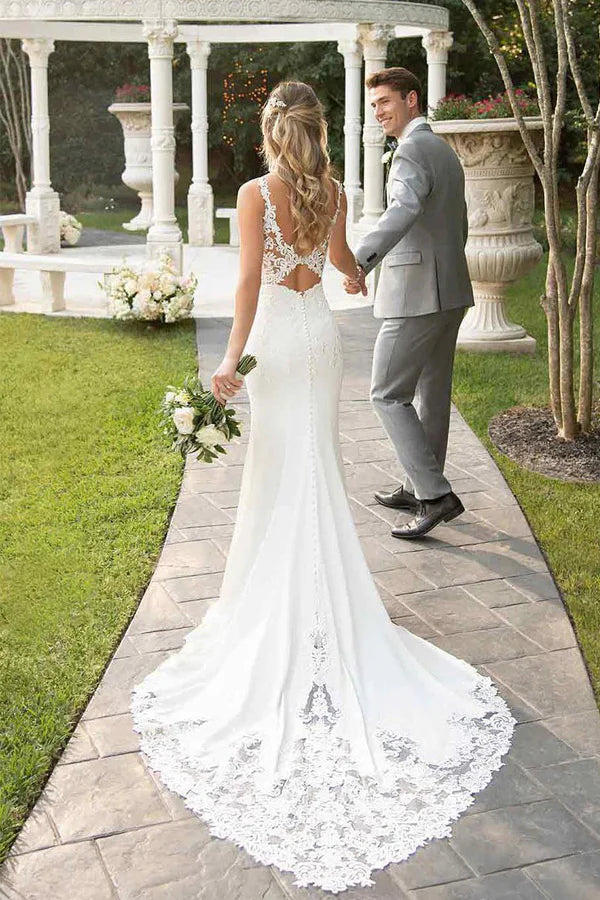 Close-up of lace straps and court train on an ivory mermaid wedding dress.
