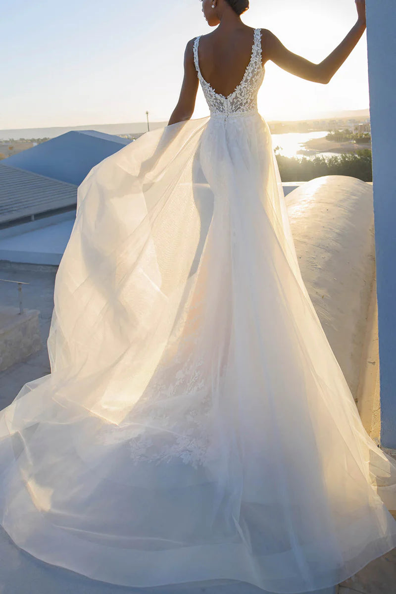 Bride wearing a mermaid V-neck wedding gown with intricate lace details.
