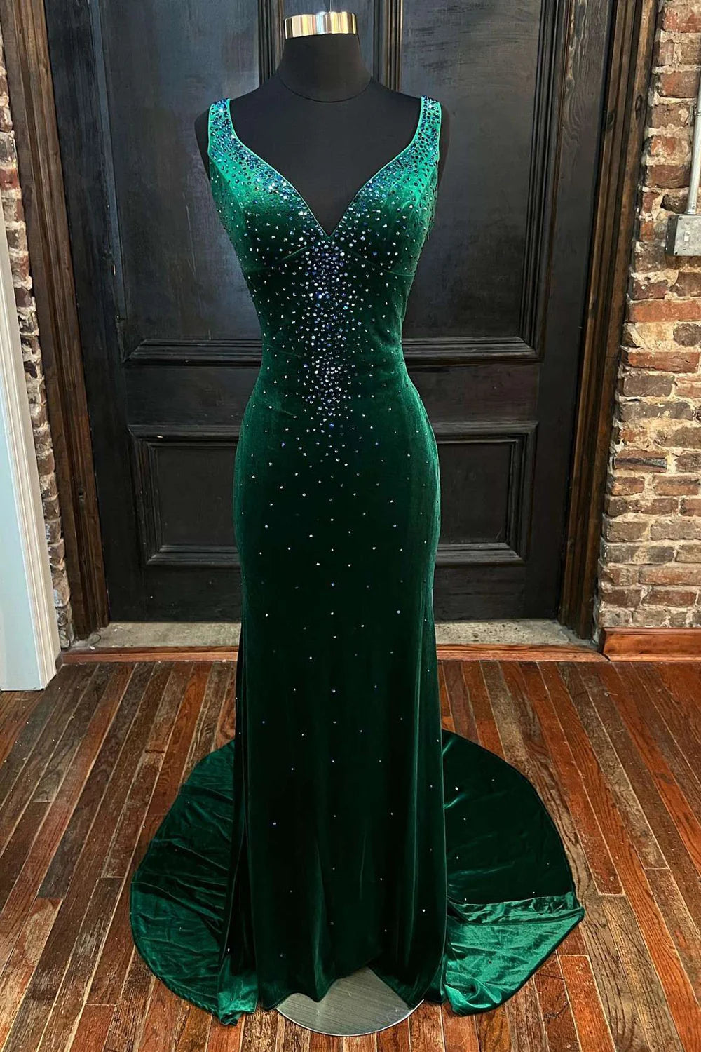 Model wearing an elegant mermaid V-neck long prom dress with a cutout back.
