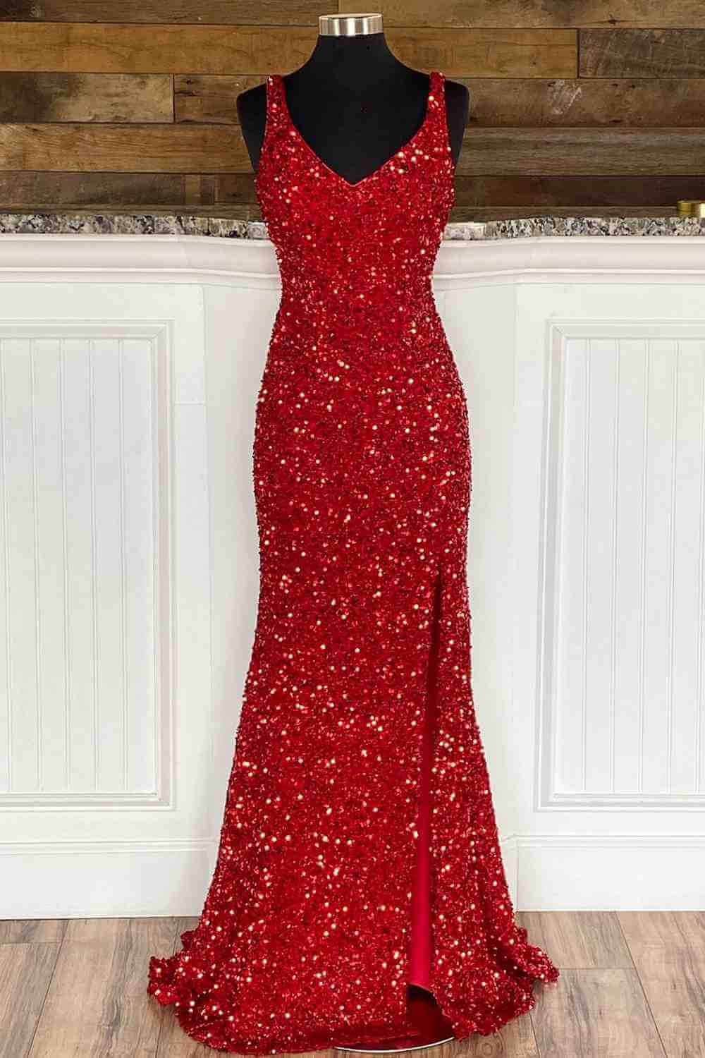 Red mermaid formal gown with a side slit.