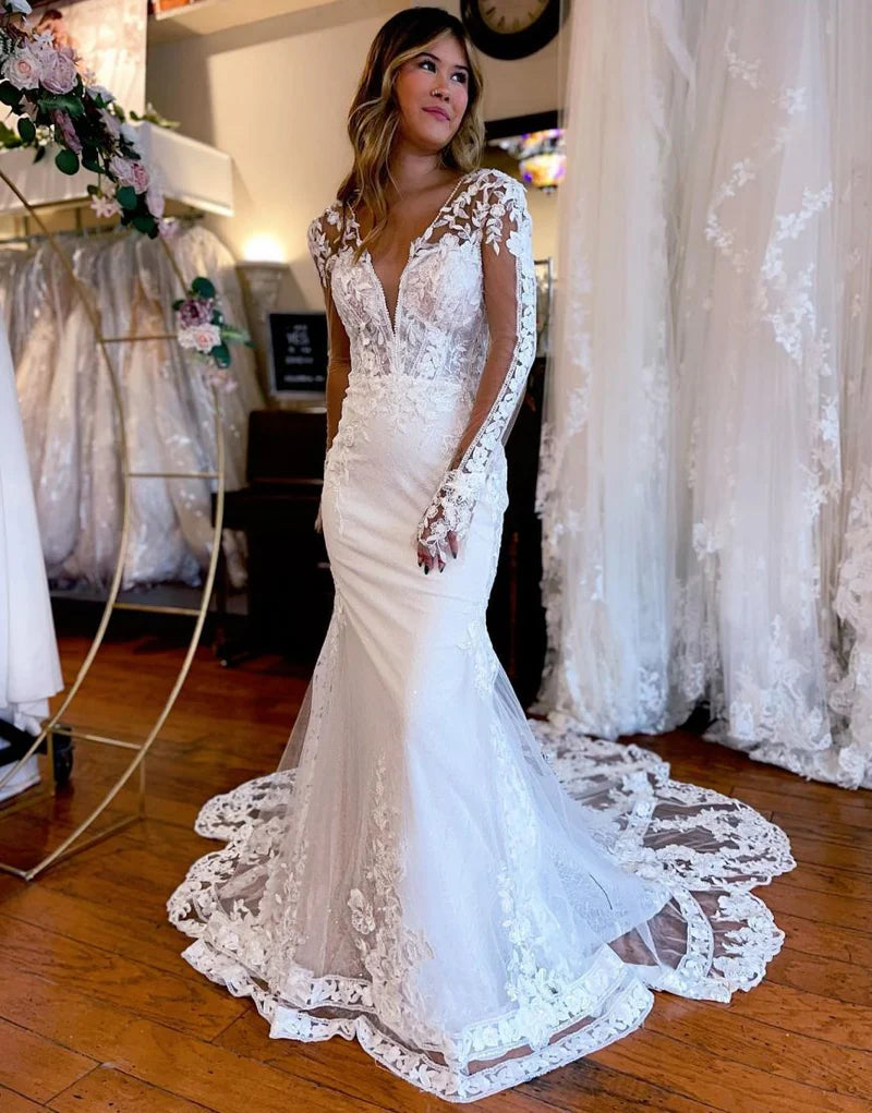 Front view of an elegant mermaid V-neck long sleeve wedding dress with intricate appliques.