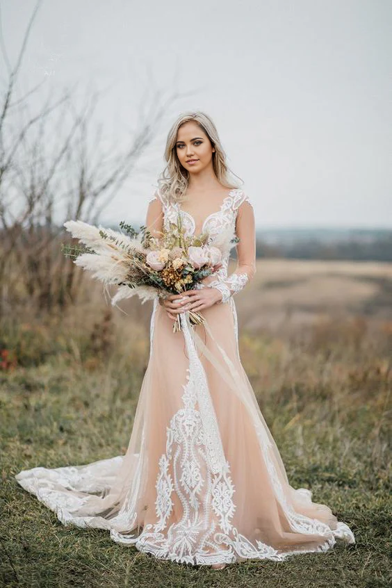 Mermaid bohemian wedding dress with long sleeves and V-neck, adorned with appliques.