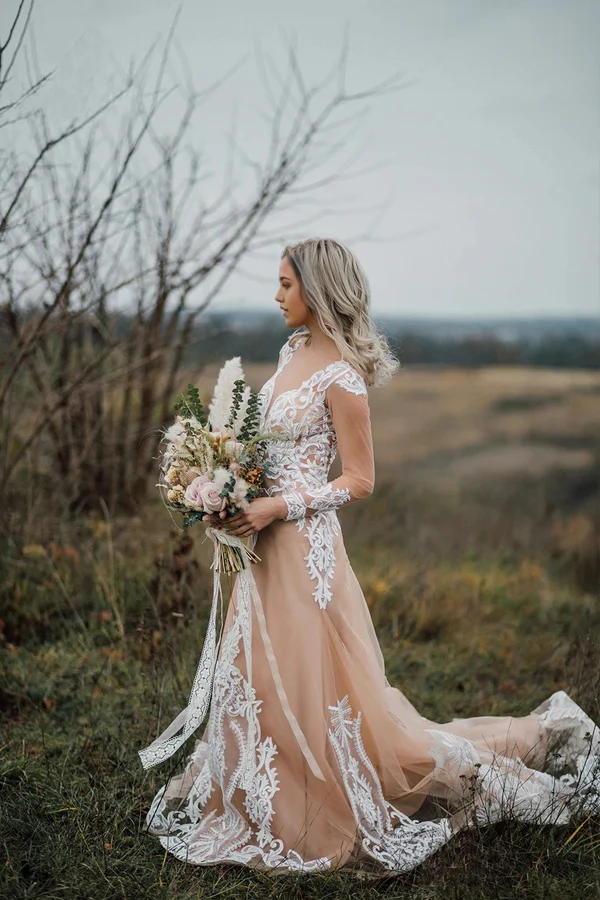Side profile of a bride wearing a long sleeve mermaid wedding gown.