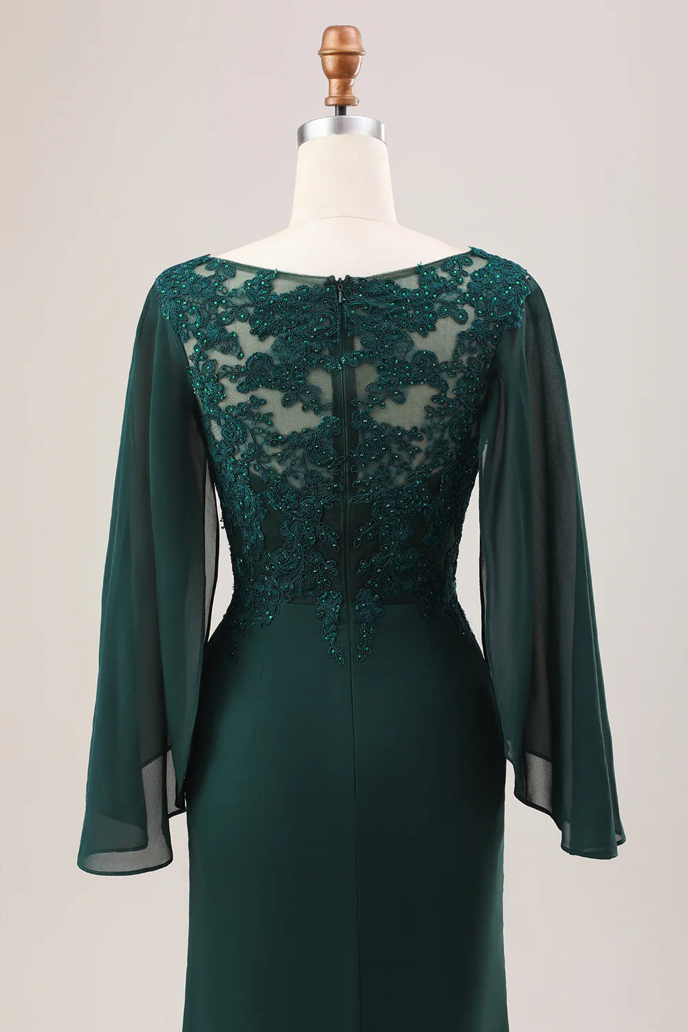 Close-up of the glitter chiffon fabric on the dark green dress.