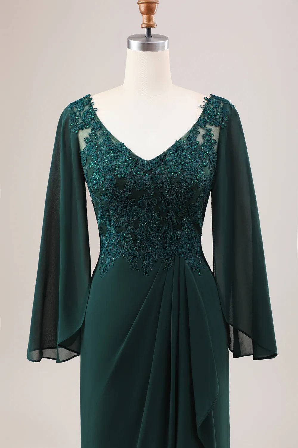 Side profile of the dark green mermaid dress, highlighting the silhouette.