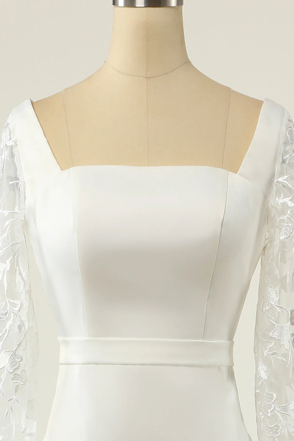 Back view of a white mermaid wedding dress with lace details.