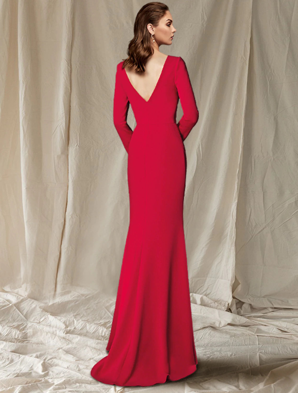 Back view of the mermaid Mother of the Bride dress showing the sweep train and button details on sleeves.