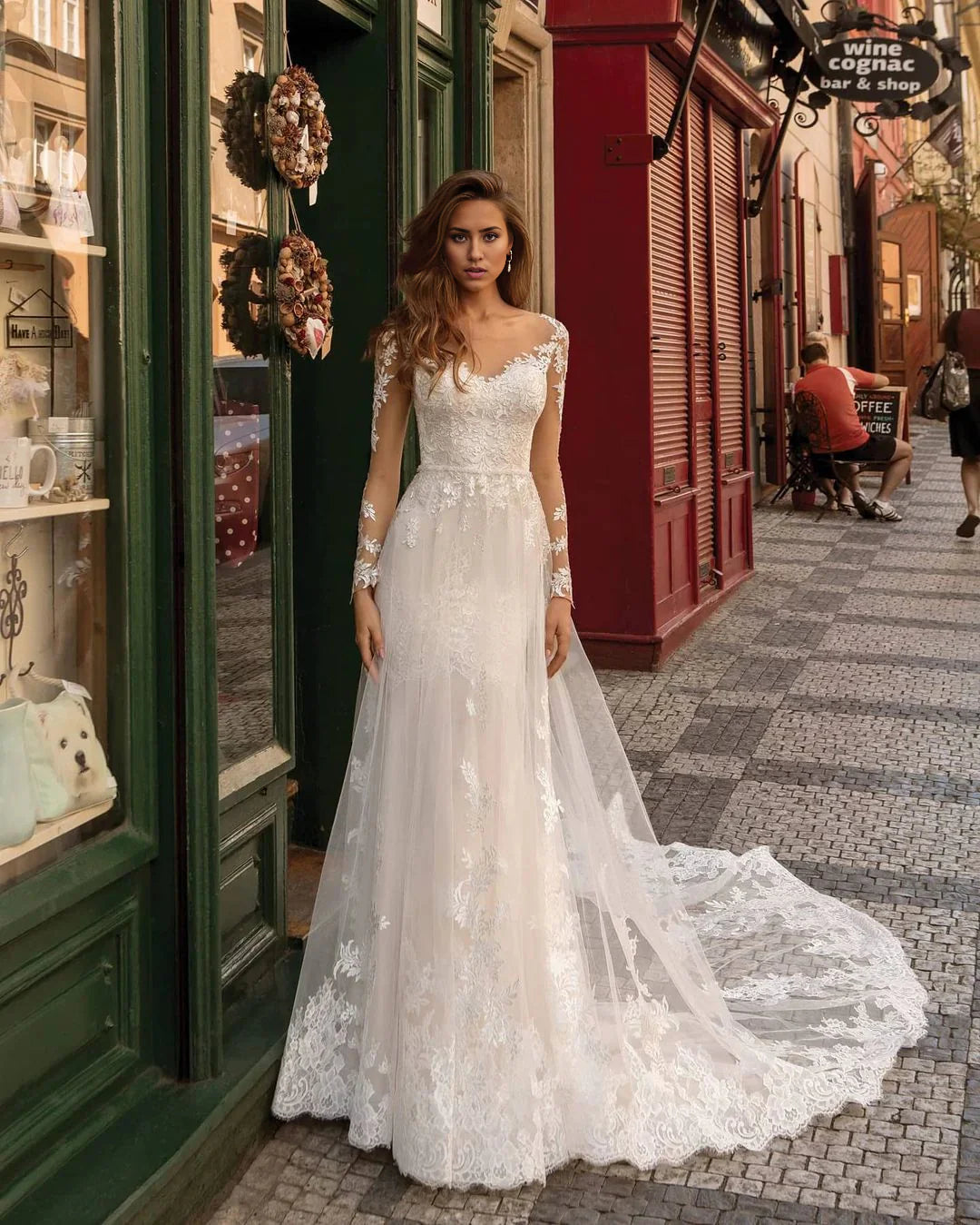 Elegant mermaid wedding dress with long lace sleeves and V-neckline.