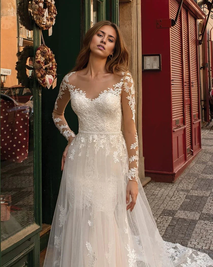 Close-up of the delicate lace detailing on a long sleeve wedding dress.