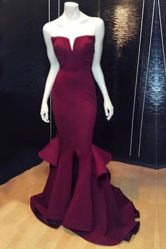 Elegant mermaid prom dress with a high slit, worn by a model.