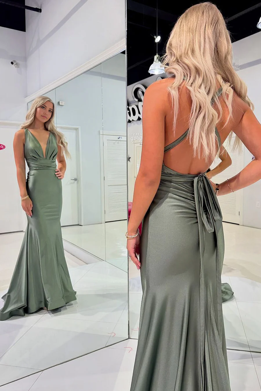 Side view of the olive green mermaid prom gown with V-neckline.